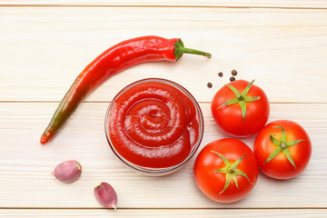 tomato, chili pepper, spices and ketchup on wooden table. top view
