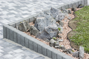 Artificially created rocks with side palisades and lawns.