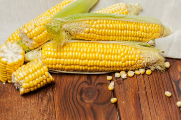 fresh corn on wooden table