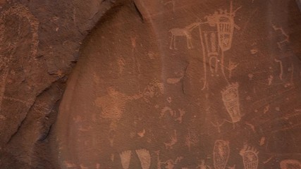 Panning view of Native American rock art on large rock near Moab Utah