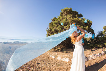 Beautiful young bride with long veil