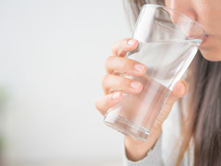 Happy beautiful young woman drinking water from glass.Health care concept.