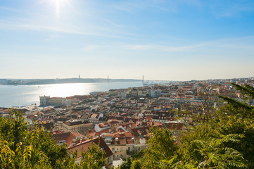 Obraz premium Lisbon roofs aerial view with bridge in the background, Portugal