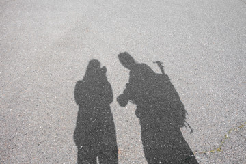 shadow of man and woman on street background
