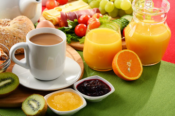 Breakfast served with coffee, orange juice, egg and fruits