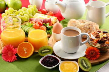 Breakfast served with coffee, orange juice, egg and fruits