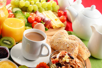 Breakfast served with coffee, orange juice, egg and fruits
