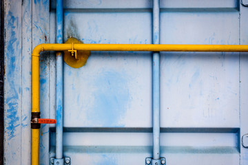 yellow piping with valve in container