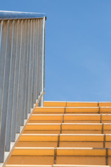 Stainless steel handrail and banister leading up outdoor tiled staircase