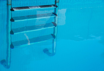 Stainless steel steps under water at a swimming pool