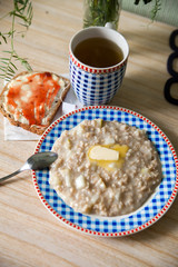 plate of oatmeal and toast with strawberry jam.