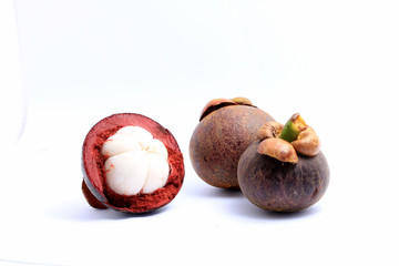 Mangosteen and another cut in half isolated on white background.