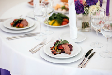 Banquet in restaurant. Table setting, fresh food.