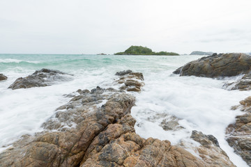 Sea waves hitting rocks on the beach