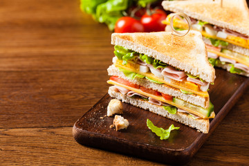 Delicious toast sandwich with ham, cheese, egg and vegetables.