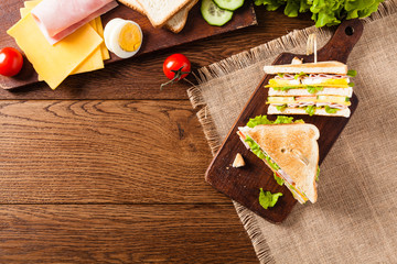 Delicious toast sandwich with ham, cheese, egg and vegetables.