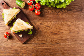 Delicious toast sandwich with ham, cheese, egg and vegetables.