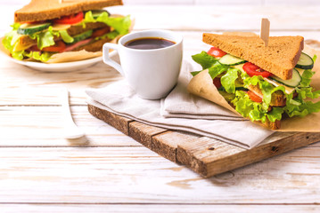 Rye bread sandwich with ham, cheese, lettuce and coffee