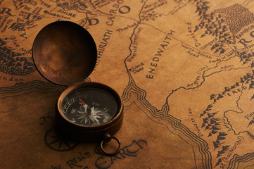 Old compass on a vintage map. Treasure and adventure search