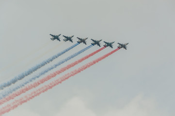 Russia, Saint-Petersburg, July 30, 2017, in celebration of the Navy, the flight of aircraft made out of the smoke a Russian flag over the city.