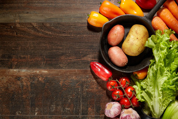 Healthy Food & drink diet Italian lifestyle: Mediterranean fruits vegetables herbs spices. Top view. Wooden rustic background. Free space text layout