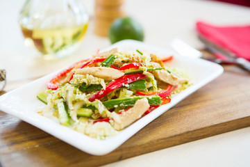 Homemade Vegetable salad on a plate on wooden cutting board