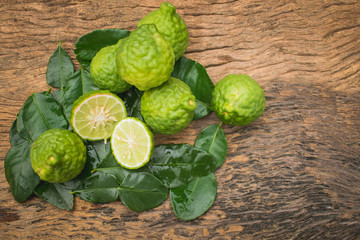 Cross section bergamot and bergamot leaf laying on wooden background. top view