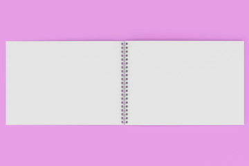 Obraz premium Open blank white notebook with metal spiral bound on violet background
