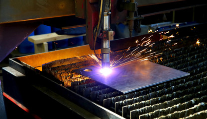 Industrial cnc plasma cutting of metal plate. Sparks fly. Closeup