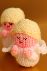Knitted Christmas angels on a gold background