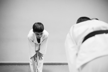 Children in kimono begin training on aikido