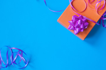  Gift with pink ribbon on blue background
