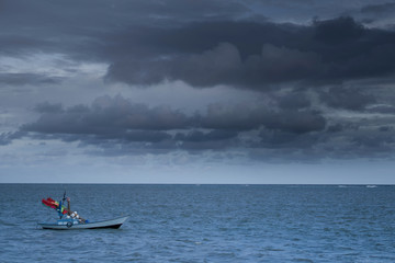 Fishing boats Float on the sea in dark sky and storm coming