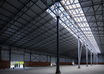A huge warehouse. Metal construction. Grain dryer. Threshing floor. Blurred-unrecognizable faces of people. Concept theme is the production of food and agricultural production.