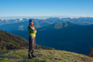 Fototapeta na wymiar Adventurer admiring the stunning mountain view