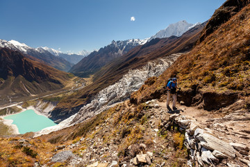 Naklejka premium Hiker is climbig to Manaslu base camp in highlands of Himalayas on Manaslu circuit