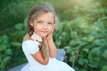 Cute little girl on nature in summer day
