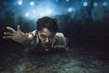 Creepy asian zombie man lying down on with wounded face