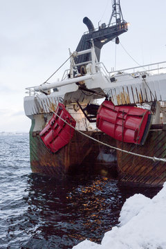 A Norwegian fishing boat parked in the port of &Aring;lesund, Norway