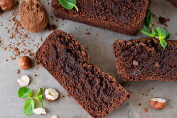 Homemade chocolate brownies with nuts on a metal, grunge background