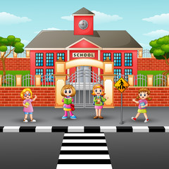Fototapeta na wymiar Children crossing the street in front school