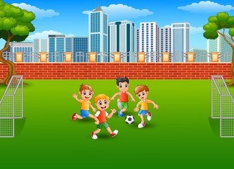 Obraz na płótnie Canvas Children playing soccer in the park
