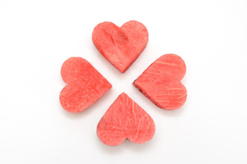 Fresh watermelon slice with carved hearts on white background