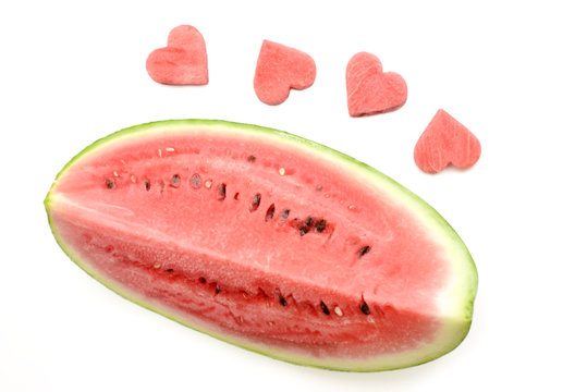 Fresh watermelon slice with carved hearts on white background