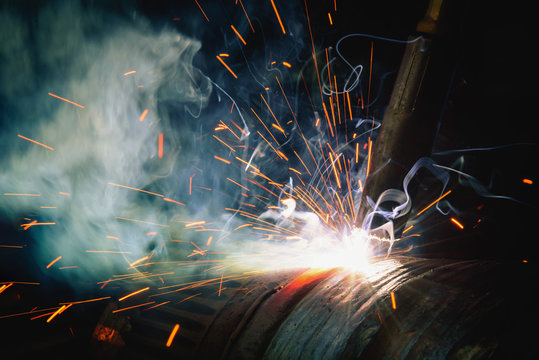 Welding steel structures and bright sparks in steel construction industry.