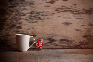 Cup and hearts on old wood.