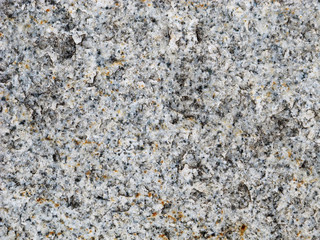 The texture of gray granite with inclusions of rust
