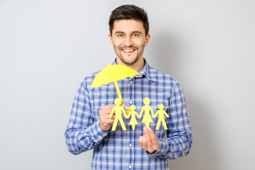 Concept of family insurance with umbrella protecting a family