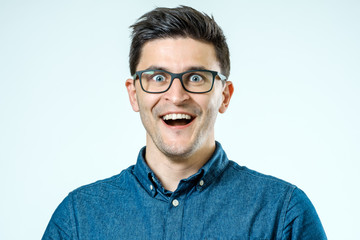 Obraz premium Portrait of a young beautiful man with surprised face expression