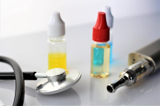 An image of a e cigarette and a stethoscope - health